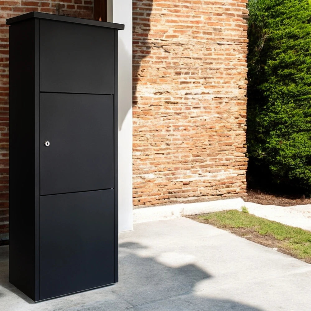 Black outdoor parcel box for home, Goldcrest model, freestanding next to a wall